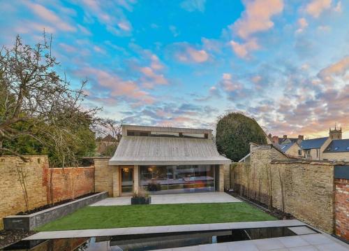 a house with a metal roof and a brick wall at Luxury Guest House in Woodstock