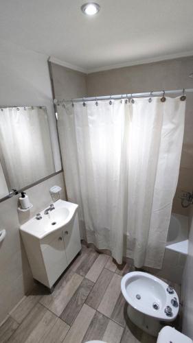 a bathroom with a sink and a toilet and a shower at SoHo Flat in Tandil