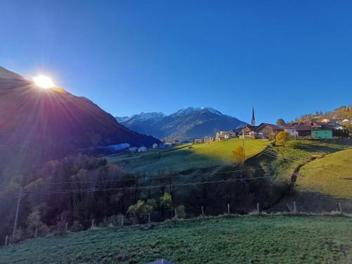 a view of a mountain with the sun shining on it at Neuner Charlotte Preise inclusive Sommercard in Wenns