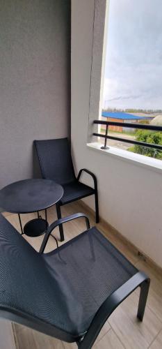 a room with a chair and a table and a window at Portovaradin in Petrovaradin