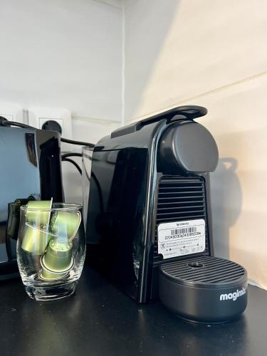 a coffee maker and a glass on a counter at Studio pirate of the Caribbean 2 sea view in Marigot