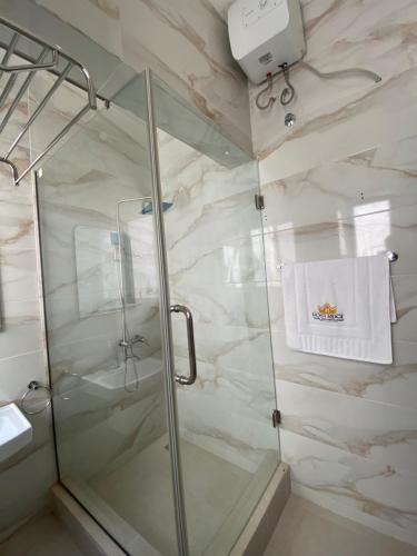 a shower in a bathroom with a glass shower stall at Post Ridge Hotel in Accra