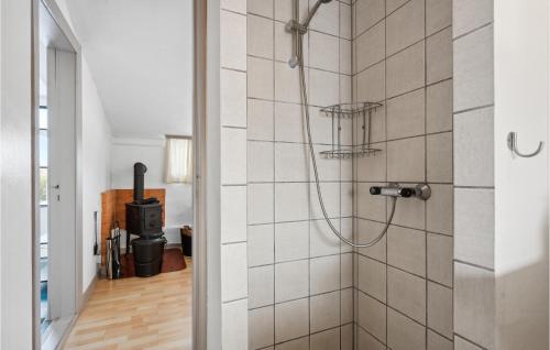 a shower in a bathroom with a tile wall at Beautiful Apartment In Ringkbing With Wifi in Ringkøbing
