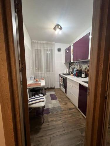 a kitchen with a sink and a table in it at Bucharest Apartment in Bucharest