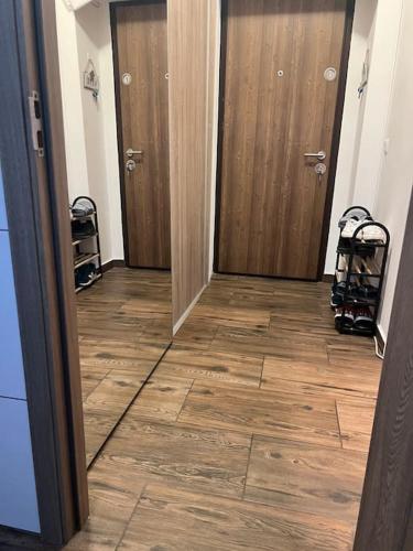 a hallway with two doors and a wood floor at Bucharest Apartment in Bucharest