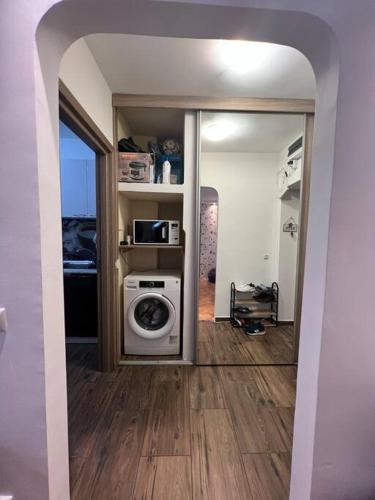 a living room with a washing machine in a room at Bucharest Apartment in Bucharest