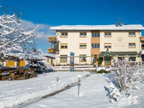 a large building with snow on the ground at Wellnesshotel Sonnenhof & Sonnhalde in Ühlingen-Birkendorf