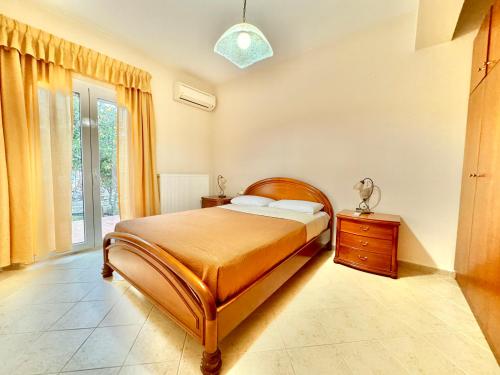 a bedroom with a bed and a dresser and a window at Giorgos Large Size Apartments -Family Friendly with Free Parking and Yard Views in Heraklio