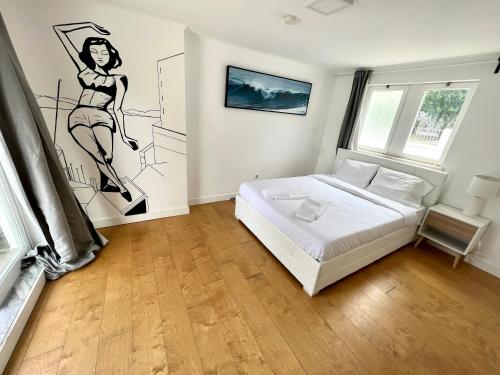 a bedroom with a bed with a drawing on the wall at Double Bedroom near Beach with Private terrace 3rd floor No Lift Room 9 in Oeiras