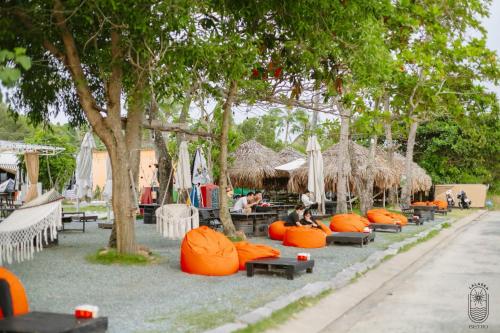 a group of orange bean bags sitting on the ground at LALASEA BISTRO (Camping, Food & Drink) in Ha Tien