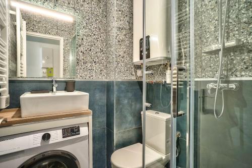 a bathroom with a washing machine and a sink at Splendid apartment for 2 people in Aubervilliers