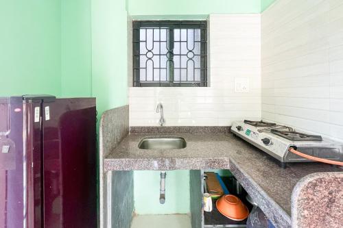 a kitchen with a sink and a stove at Jolene's Mandrem in Mandrem