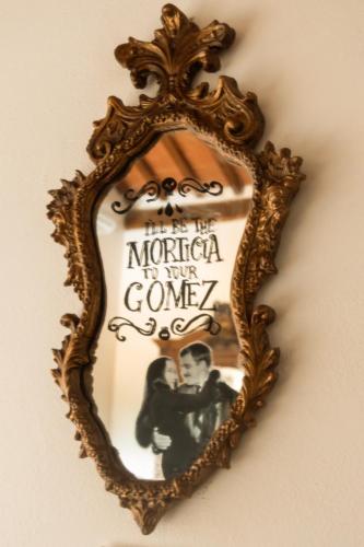 a mirror on a wall with a picture of a man at Tenuta Massabò in San Casciano in Val di Pesa