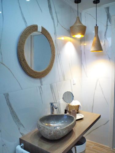 a bathroom with a stone sink and a mirror at Nostos Luxury Villas with Private Pool in Nafpaktos in Nafpaktos