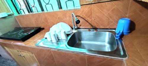 a kitchen sink with a faucet on a counter at LE Transient Homes - SC in Baguio