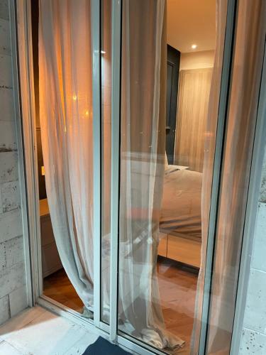 a window with curtains and a bed in a room at 30° apartment paradise of the sun in Agadir