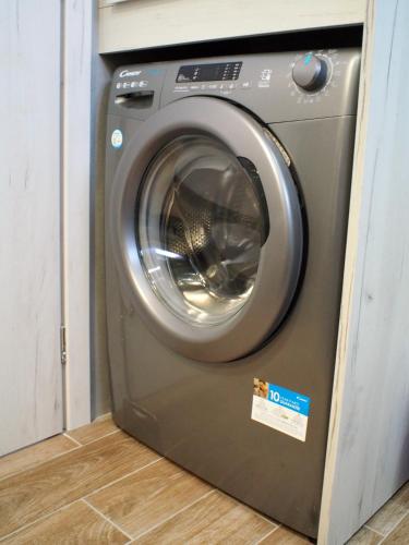a washing machine with a sticker on it in a room at Nostos Luxury Villas with Private Pool in Nafpaktos in Nafpaktos