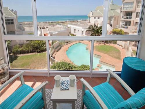 a balcony with chairs and a view of the ocean at Summerseas in Summerstrand