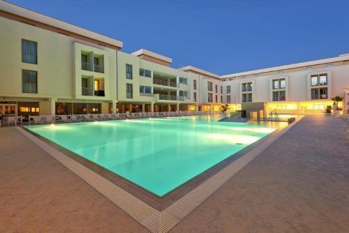 a large swimming pool in the middle of a building at Hotel Terme Marine Leopoldo II TERME & SPA in Marina di Grosseto
