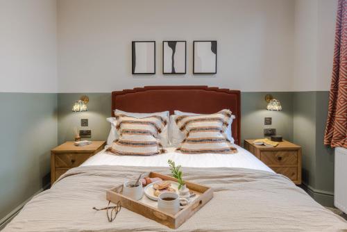 a bed with a tray of food on it at Redland Place - Your Apartment in Bristol