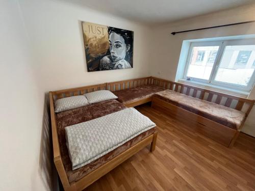 a room with a bed and a bench and a window at Mikulovská chalupa in Mikulov