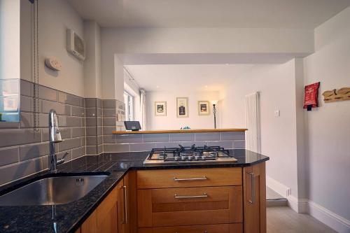 a kitchen with a sink and a stove at Host & Stay - Roselyn By The Sea in Newbiggin-by-the-Sea