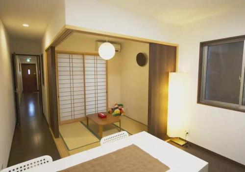 a room with a table and chairs and a window at Hanagoyomi in Kyoto