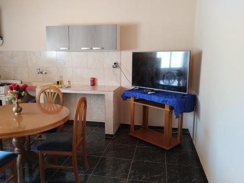 a kitchen with a table with a tv on it at Departamento El Inca in Fiambala