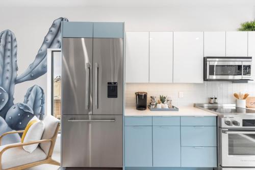 a kitchen with a stainless steel refrigerator at Perfect Friends Escape in Old Town Scottsdale with Resort Pool Access and Roof Deck! in Scottsdale