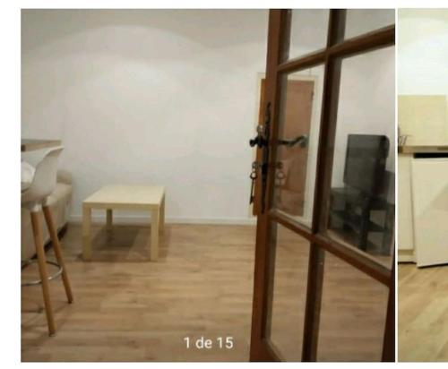ein Wohnzimmer mit einer Glasschiebetür und einem Tisch in der Unterkunft Maison de village proche regain EDF CEA in Sainte-Tulle