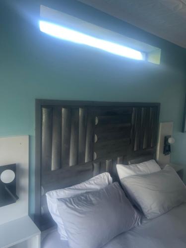 a bedroom with a bed with a blue light above it at 28 on Symonds luxstudio 6 in George