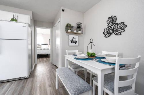 a white dining room with a white table and chairs at A Cozy and Peaceful Stay with King Bed in Killeen