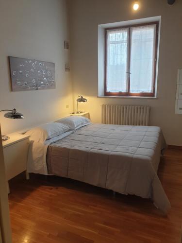 a bedroom with a bed and a desk and a window at Residence Vanvitelli in Ancona