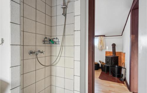 a bathroom with a shower in a room with a stove at 2 Bedroom Lovely Apartment In Ringkbing in Ringkøbing