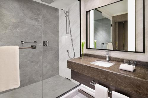 a bathroom with a sink and a shower at Al Ahsa InterContinental by IHG in Al Ahsa