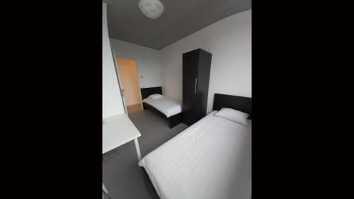 a small bedroom with a bed and a desk at Ludovic - 3 bedroom apartment in Essen