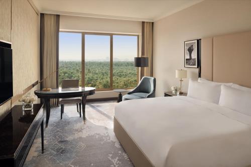 a hotel room with a bed and a desk and a window at Al Ahsa InterContinental by IHG in Al Ahsa