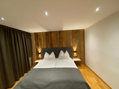 a bedroom with a large bed with two lamps at Ferienhaus Edith in Kaltenbach