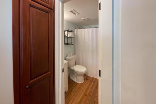 a bathroom with a toilet and a shower curtain at Driftwood Villa - 280 in Edisto Beach