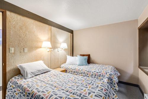 a hotel room with two beds and two lamps at Sunny, Spacious & Pet Friendly - Creekside #39 in Bear Valley