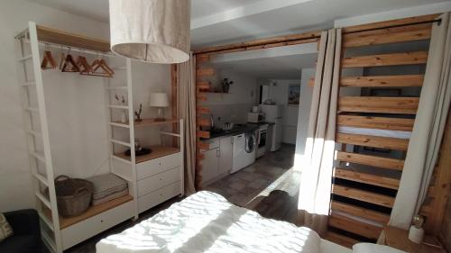 a room with a bed and a kitchen in a room at Chez Alphonse in Thônes