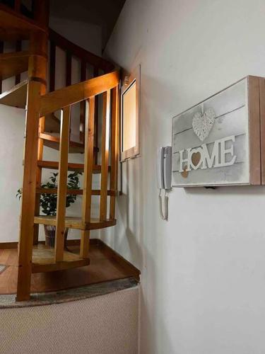 a staircase in a room with a home sign on the wall at Castle House Xativa in Xàtiva