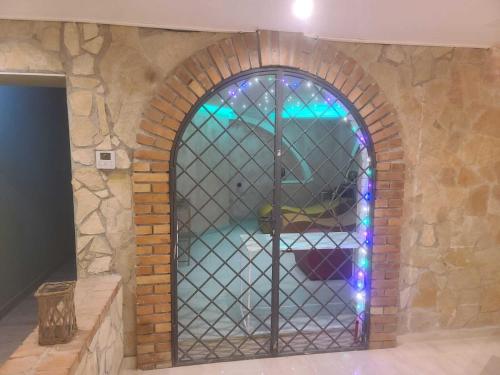 a room with a brick wall with a glass door at Riccio - La Cantina del contadino in Rende