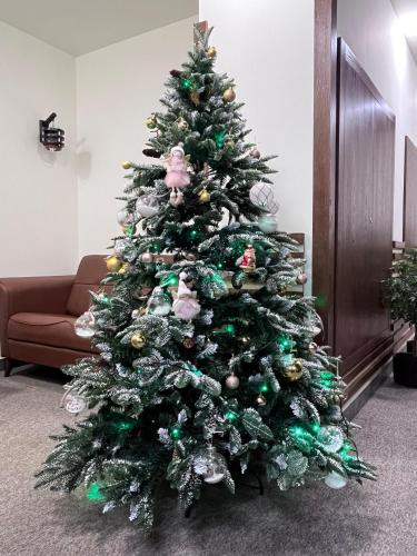 a christmas tree with green and silver ornaments at Rooftop Apart-Hotel in Yerevan