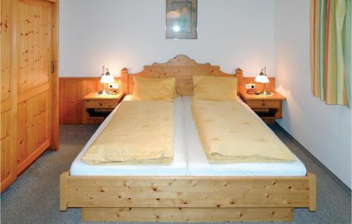 a wooden bed in a bedroom with two night stands at Awesome Apartment In Flachau With 2 Bedrooms And Wifi in Flachau