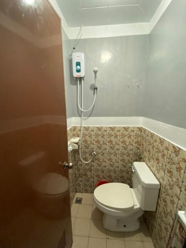 a bathroom with a toilet and a shower at Maicaellas Transient Room in Coron