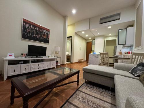 a living room with a couch and a tv at Perfect Marina @ Strait Quay /w Exclusive Stay in Tanjong Tokong