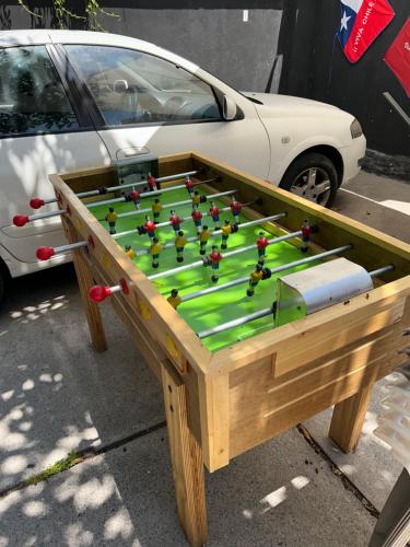 a wooden table with a pool game on it at Viva Chile Providencia - Bustamante in Santiago