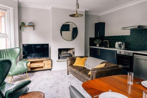 a living room with a couch and a table at Tranquility in Worthing