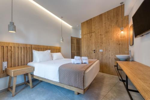 a bedroom with a large bed and a sink at Harma Boutique Hotel in Hersonissos